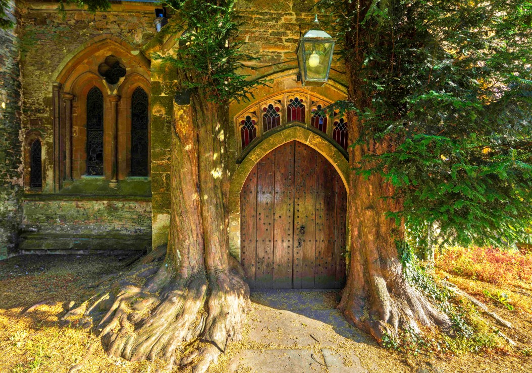 St Edwards Parish Church north door flanked by yew trees